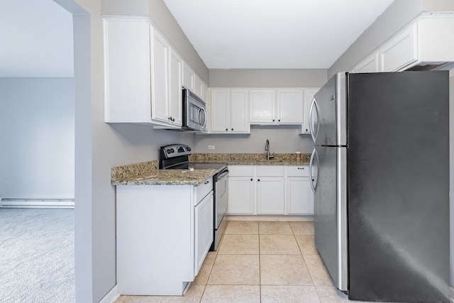 4309 W Park Lane Dr Unit 2B, Alsip, IL 60803 - kitchen featuring stainless steel appliances, light stone counters, white cabinetry, a baseboard heating unit, and light tile patterned floors