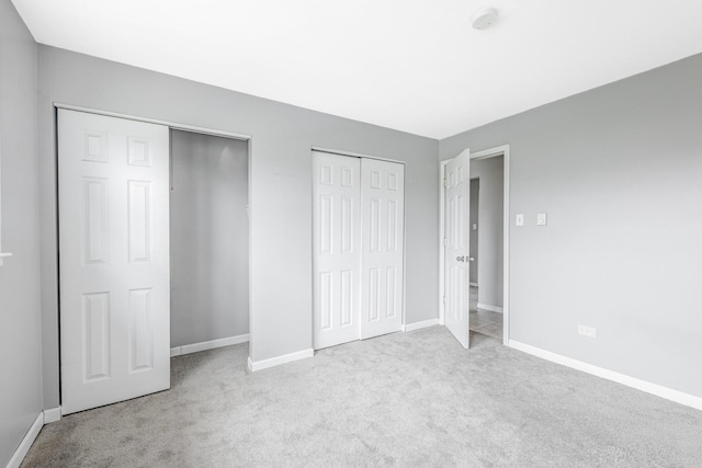 4309 W Park Lane Dr Unit 2B, Alsip, IL 60803 - unfurnished bedroom featuring multiple closets and carpet flooring