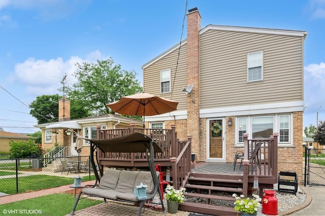 10245 Mcnerney Dr, Franklin Park, IL 60131 - back of house with brick siding, a wooden deck, a gate, and a chimney