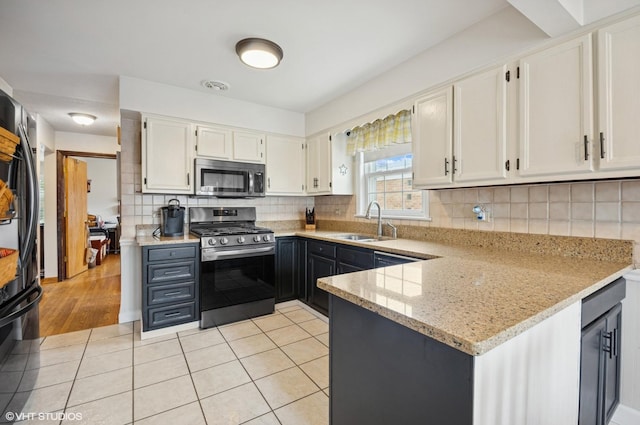 10245 Mcnerney Dr, Franklin Park, IL 60131 - kitchen featuring stainless steel appliances, light stone counters, white cabinets, backsplash, and light tile patterned floors