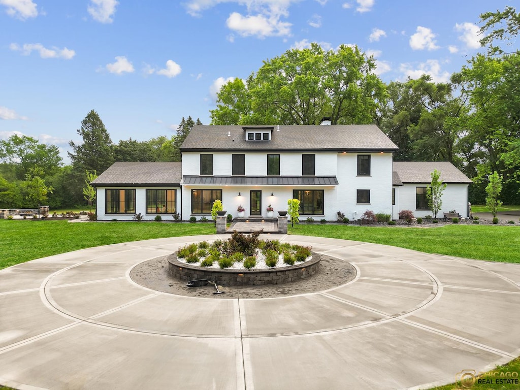 379 W County Line Rd, Barrington Hills, IL 60010 - modern farmhouse style home with curved driveway, a front lawn, view of scattered trees, and roof with shingles