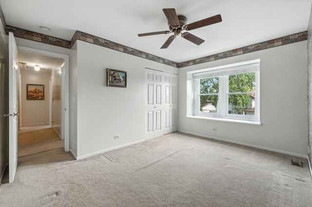 1021 Mobile Cir, Elk Grove Village, IL 60007 - unfurnished bedroom with carpet, a closet, and a ceiling fan
