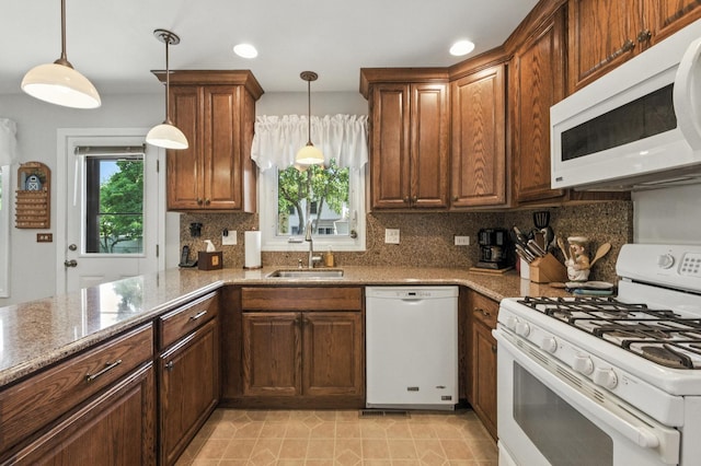 1021 Mobile Cir, Elk Grove Village, IL 60007 - kitchen with white appliances, decorative backsplash, light stone countertops, hanging light fixtures, and recessed lighting