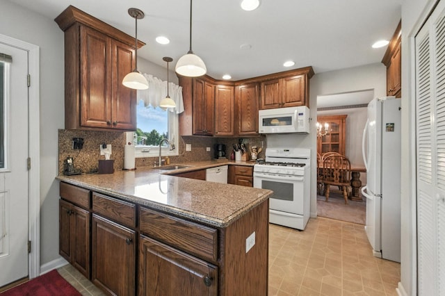 1021 Mobile Cir, Elk Grove Village, IL 60007 - kitchen featuring white appliances, tasteful backsplash, recessed lighting, a peninsula, and decorative light fixtures