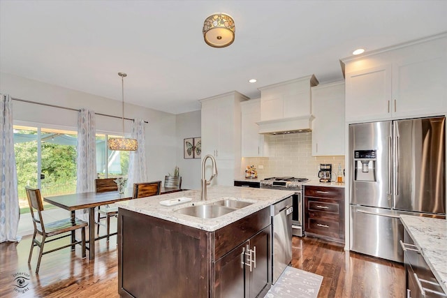 24401 S Clydesdale Ct, Manhattan, IL 60442 - kitchen with appliances with stainless steel finishes, custom exhaust hood, dark brown cabinetry, dark wood-style flooring, and light stone counters