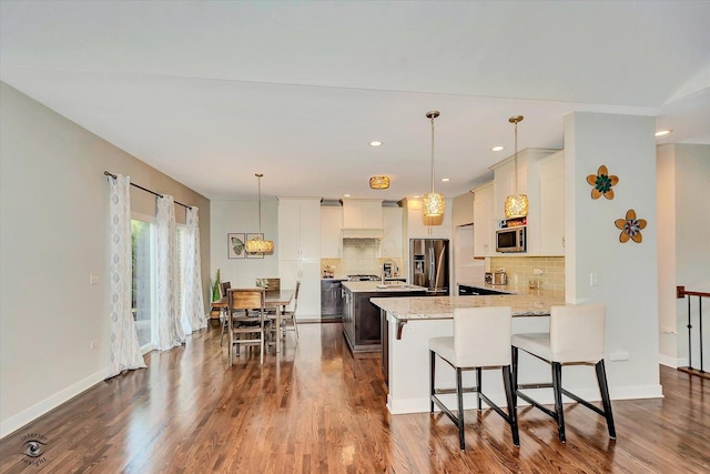 24401 S Clydesdale Ct, Manhattan, IL 60442 - kitchen featuring appliances with stainless steel finishes, a peninsula, tasteful backsplash, dark wood finished floors, and recessed lighting