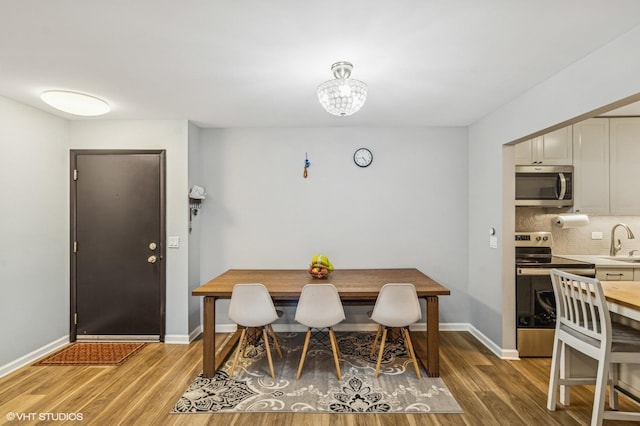 1111 Pleasant Run Dr Unit 905, Wheeling, IL 60090 - dining room with light wood finished floors and a chandelier