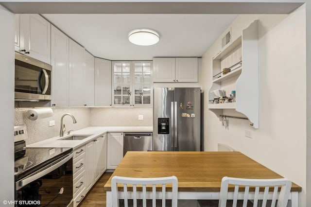 1111 Pleasant Run Dr Unit 905, Wheeling, IL 60090 - kitchen featuring appliances with stainless steel finishes, white cabinets, glass insert cabinets, and dark wood-type flooring