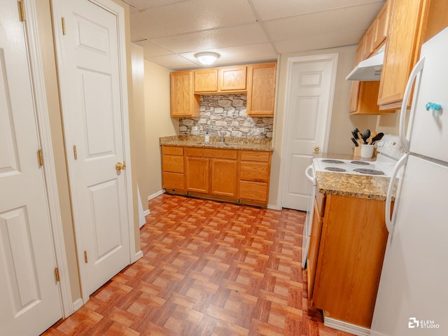 424 Grape Vine Trl, Oswego, IL 60543 - kitchen with white appliances, a drop ceiling, under cabinet range hood, decorative backsplash, and light stone counters