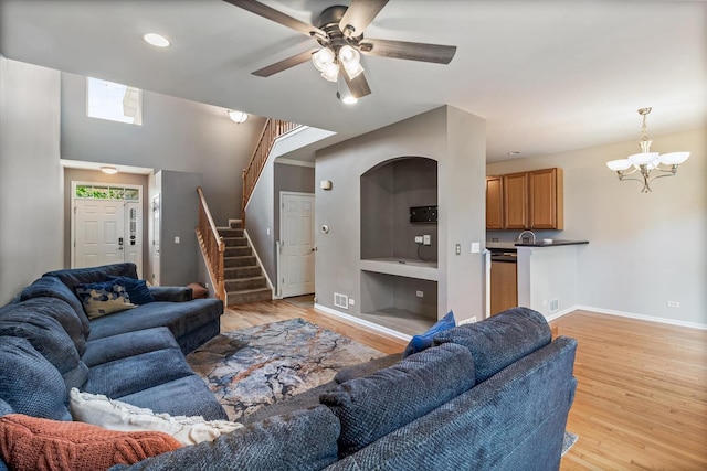 627 S Jade Ln, Round Lake, IL 60073 - living area featuring stairs, a chandelier, light wood finished floors, a ceiling fan, and recessed lighting