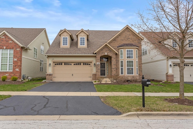 1780 Briarheath Dr, Aurora, IL 60505 - view of front of house featuring brick siding, asphalt driveway, a shingled roof, a garage, and a front yard