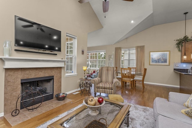 1780 Briarheath Dr, Aurora, IL 60505 - living room featuring a ceiling fan, wood finished floors, vaulted ceiling, and a fireplace