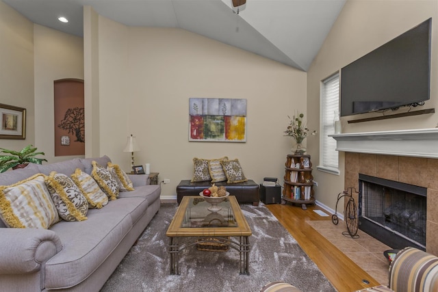 1780 Briarheath Dr, Aurora, IL 60505 - living room with a tile fireplace, wood finished floors, a ceiling fan, recessed lighting, and high vaulted ceiling