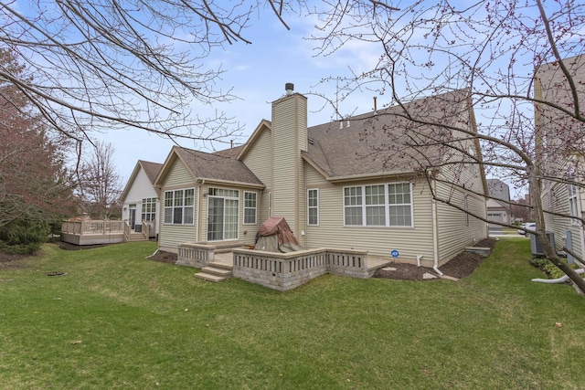 1780 Briarheath Dr, Aurora, IL 60505 - back of house featuring a wooden deck, a chimney, a lawn, and roof with shingles