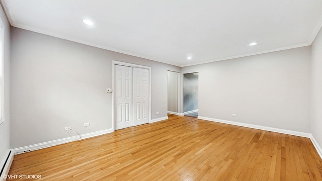 4629 Main St Unit 2A, Skokie, IL 60076 - unfurnished bedroom featuring light wood-type flooring, baseboard heating, ornamental molding, two closets, and recessed lighting