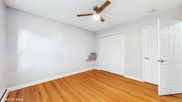 4629 Main St Unit 2A, Skokie, IL 60076 - unfurnished bedroom featuring a wall unit AC, light wood finished floors, baseboard heating, a closet, and ceiling fan