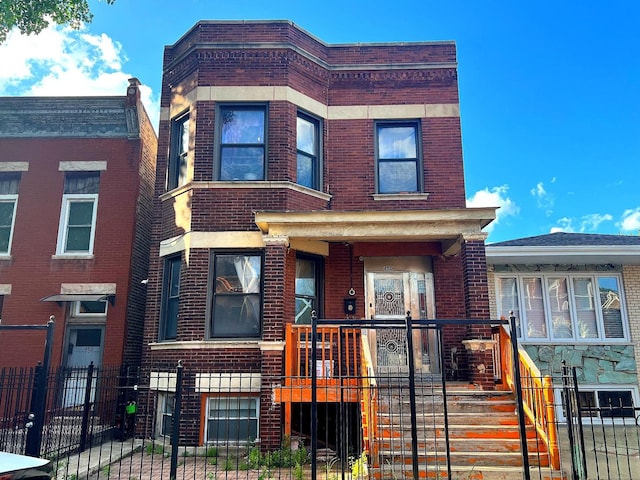 450 W 29th St, Chicago, IL 60616 - view of front of house featuring brick siding, a fenced front yard, and a gate