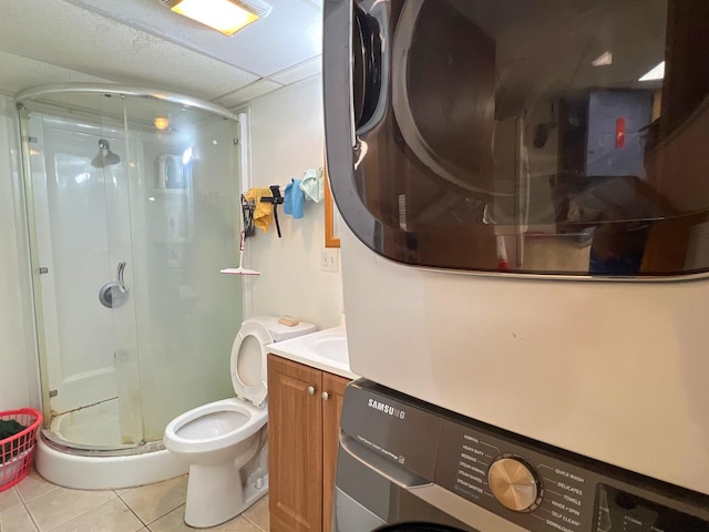 450 W 29th St, Chicago, IL 60616 - full bath with estacked washer and dryer, tile patterned floors, a shower stall, and vanity