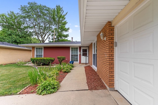 5475 Adeline Pl, Oak Forest, IL 60452 - doorway to property featuring brick siding, an attached garage, and a lawn