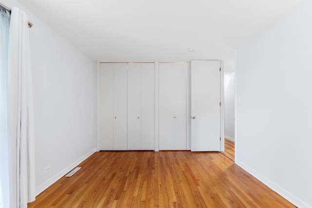 5475 Adeline Pl, Oak Forest, IL 60452 - unfurnished bedroom with light wood-type flooring and two closets
