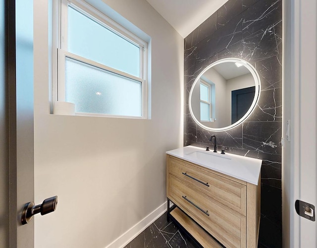 300 N Lockwood Ave, Chicago, IL 60644 - bathroom with marble finish flooring, vanity, and backsplash