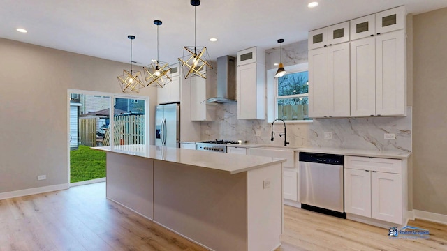 300 N Lockwood Ave, Chicago, IL 60644 - kitchen with stainless steel appliances, wall chimney range hood, light wood finished floors, a center island, and recessed lighting