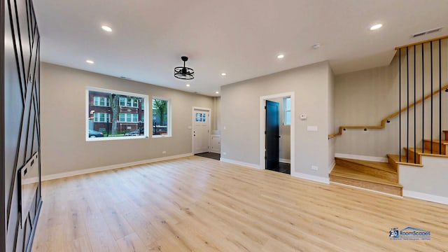 300 N Lockwood Ave, Chicago, IL 60644 - unfurnished living room with wood finished floors, stairway, and recessed lighting