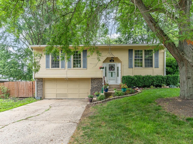 615 S 12th Ave, Saint Charles, IL 60174 - split foyer home with a garage, brick siding, and concrete driveway
