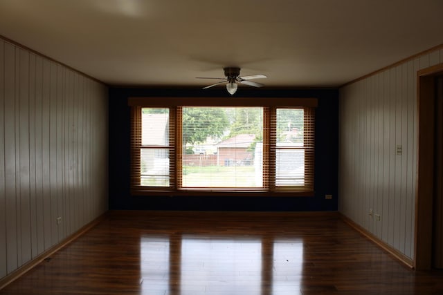 316 Marguerite St, Elgin, IL 60123 - empty room with ornamental molding, wood finished floors, a ceiling fan, and wooden walls