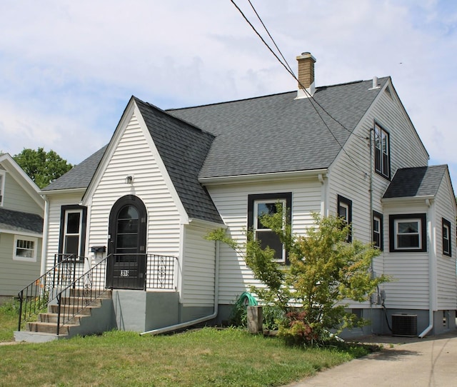 316 Marguerite St, Elgin, IL 60123 - view of front facade featuring a shingled roof and a chimney