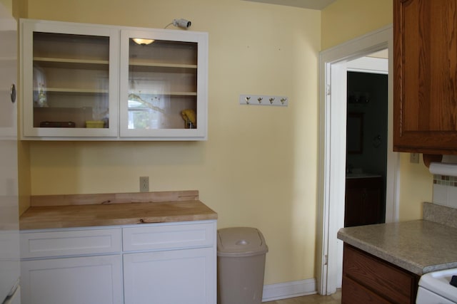 316 Marguerite St, Elgin, IL 60123 - kitchen with white cabinetry, glass insert cabinets, and wooden counters