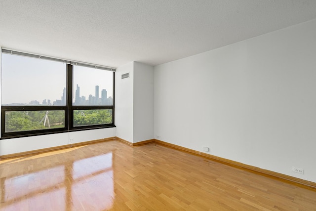 360 E Randolph St Unit 503, Chicago, IL 60601 - unfurnished room featuring light wood-type flooring and a textured ceiling