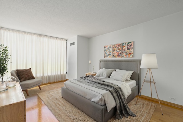 360 E Randolph St Unit 503, Chicago, IL 60601 - bedroom with light wood-style floors and a textured ceiling
