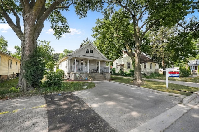 208 Frank Ave, Joliet, IL 60435 - bungalow-style house with covered porch and a chimney