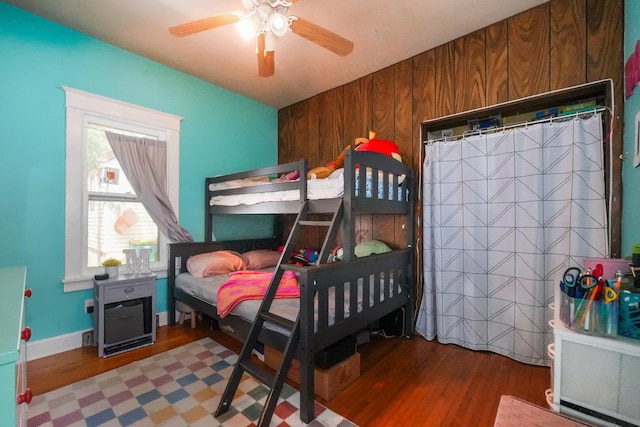 208 Frank Ave, Joliet, IL 60435 - bedroom featuring wood finished floors, a ceiling fan, and wood walls