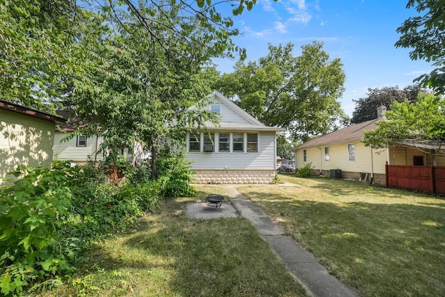 208 Frank Ave, Joliet, IL 60435 - back of property with a lawn, a fire pit, and a patio area