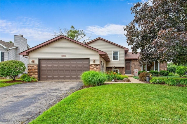 2519 Penn Blvd, Lindenhurst, IL 60046 - split level home featuring brick siding, a garage, asphalt driveway, and a front yard