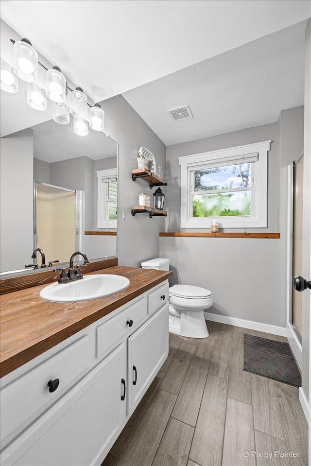 2519 Penn Blvd, Lindenhurst, IL 60046 - bathroom with vanity, a stall shower, and wood finished floors