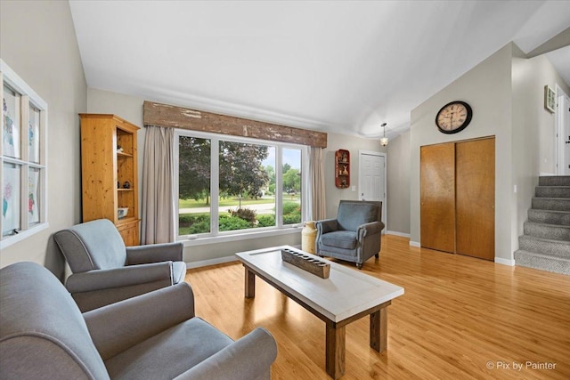 2519 Penn Blvd, Lindenhurst, IL 60046 - living area featuring lofted ceiling, light wood-style flooring, and stairs