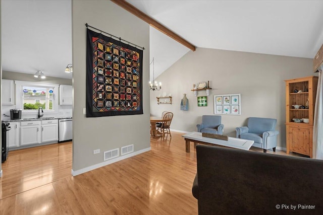 2519 Penn Blvd, Lindenhurst, IL 60046 - living area with beamed ceiling, light wood-style flooring, a chandelier, and high vaulted ceiling