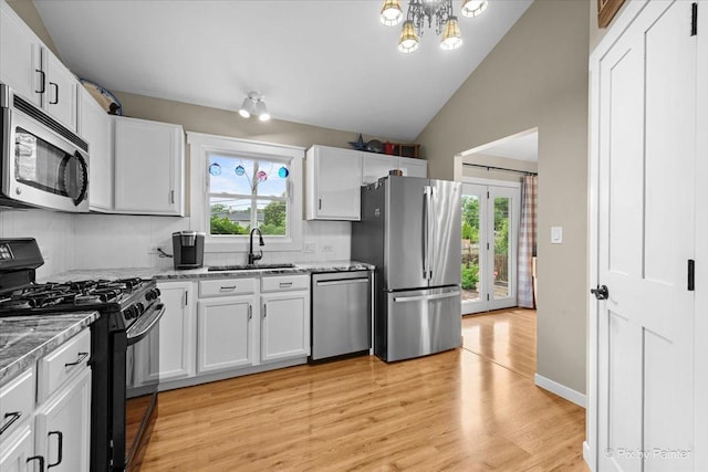 2519 Penn Blvd, Lindenhurst, IL 60046 - kitchen featuring stainless steel appliances, plenty of natural light, vaulted ceiling, light wood-type flooring, and white cabinets