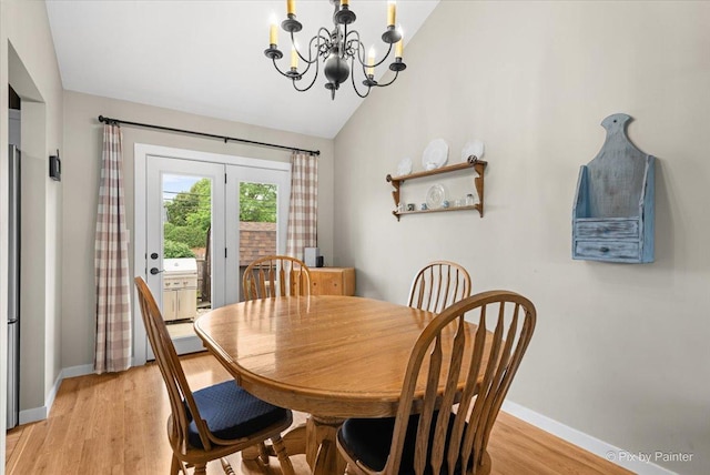 2519 Penn Blvd, Lindenhurst, IL 60046 - dining room featuring vaulted ceiling, a chandelier, and light wood finished floors
