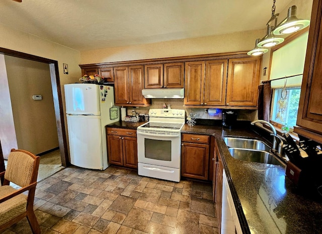 3N736 Locust Ave, West Chicago, IL 60185 - kitchen with white appliances, under cabinet range hood, brown cabinets, stone tile floors, and dark stone counters