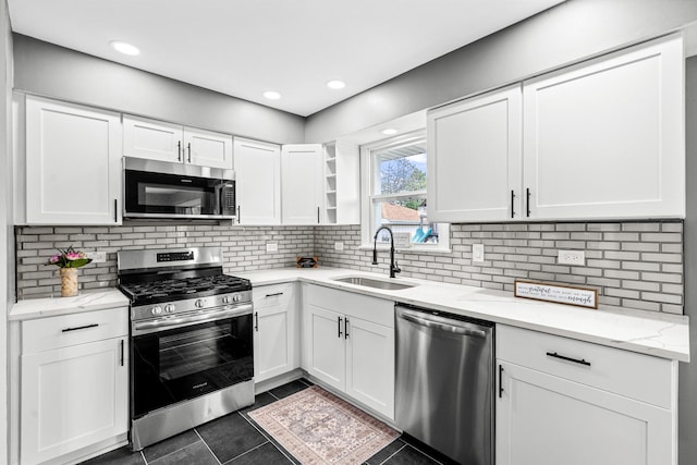 16961 Parkside Ave, South Holland, IL 60473 - kitchen with appliances with stainless steel finishes, white cabinetry, dark tile patterned flooring, light stone counters, and tasteful backsplash