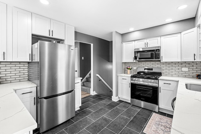 16961 Parkside Ave, South Holland, IL 60473 - kitchen with appliances with stainless steel finishes, light stone countertops, tasteful backsplash, white cabinets, and recessed lighting