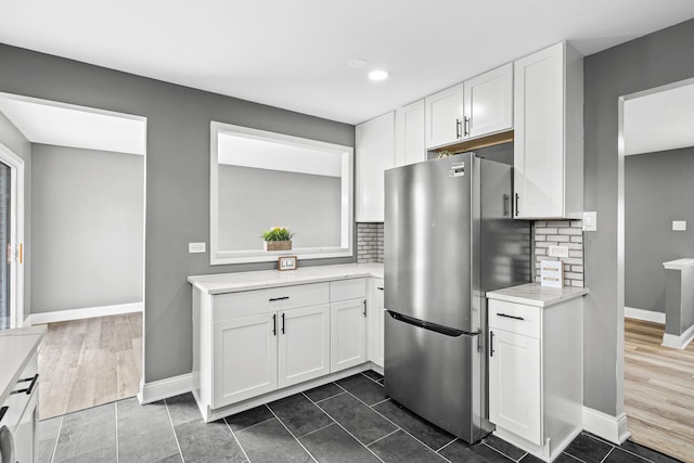 16961 Parkside Ave, South Holland, IL 60473 - kitchen featuring freestanding refrigerator, white cabinetry, decorative backsplash, and recessed lighting