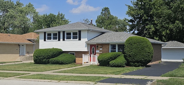 16961 Parkside Ave, South Holland, IL 60473 - split level home featuring a front lawn, brick siding, and roof with shingles