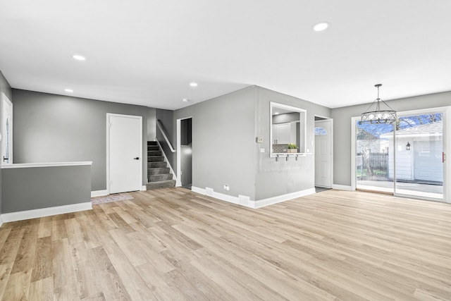 16961 Parkside Ave, South Holland, IL 60473 - unfurnished living room with light wood-type flooring, stairs, recessed lighting, and a chandelier