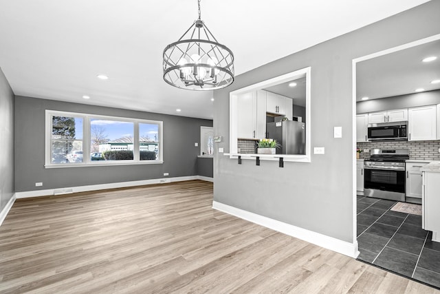 16961 Parkside Ave, South Holland, IL 60473 - unfurnished living room with a chandelier, wood finished floors, and recessed lighting