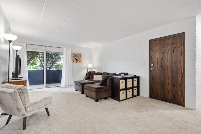 491 Timber Ridge Dr Unit 104, Carol Stream, IL 60188 - carpeted living room featuring brick wall